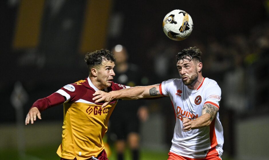 Motherwell's Davor Zdravkovski and Dundee United's Will Ferry in action