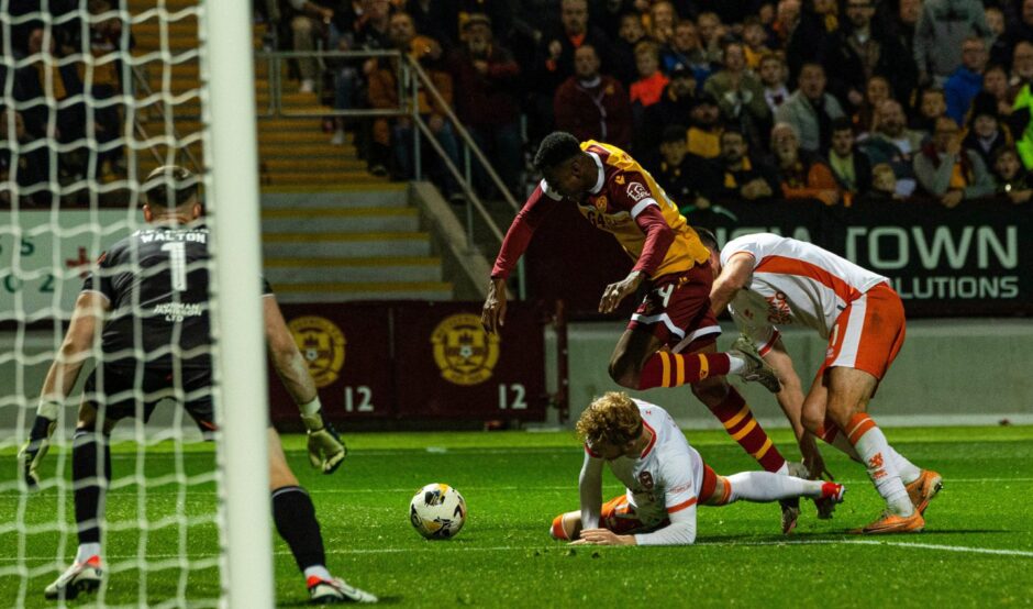 Dundee United's Luca Stephenson lunges into an ill-judged challenge