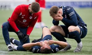 Raith's Lewis Vaughan receives treatment as Jack Hamilton crouches down.