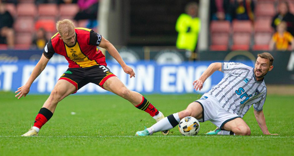 Craig Clay puts in a challenge on Partick Thistle's Harry Milne.