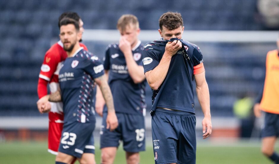 Raith Rovers skipper Ross Matthews hides his face in his strip at the full-time whistle.