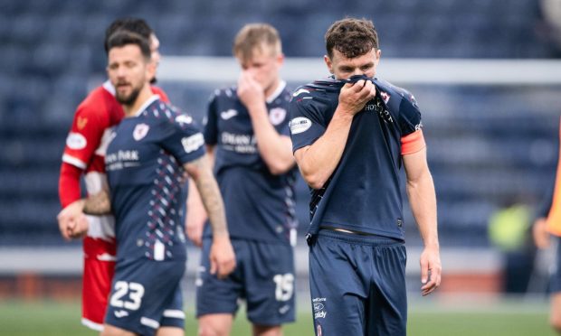 Disappointed Raith Rovers captain Ross Matthews hides his face in his strip.