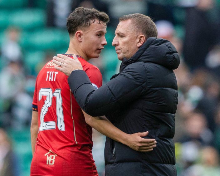 Dylan Tait is congratulated on his performance by Celtic manager Brendan Rodgers.