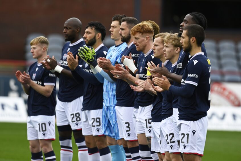 Dundee players lead the minute's applause to say goodbye to Fabian Caballero. Image: Rob Casey/SNS