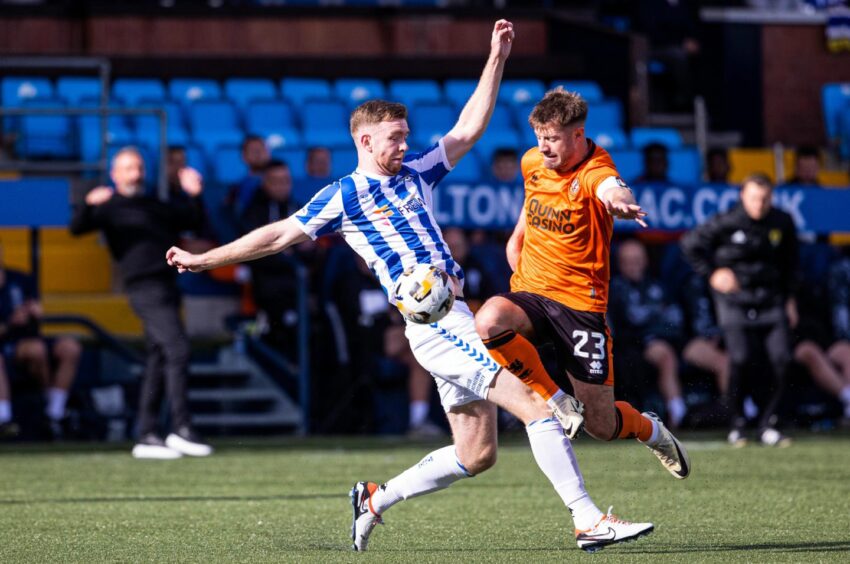 Dundee United Captain Ross Docherty, right, battles for possession.