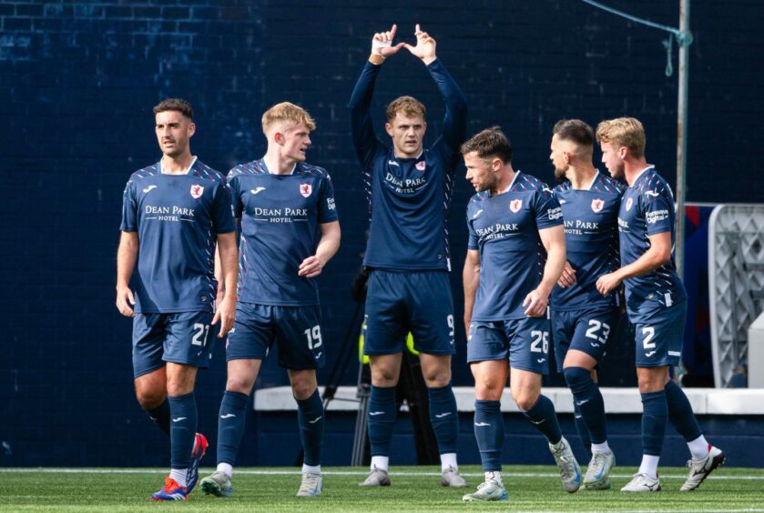 Jack Hamilton makes a 'W' sign with his hands as he celebrates his match-winning penalty against Falkirk.