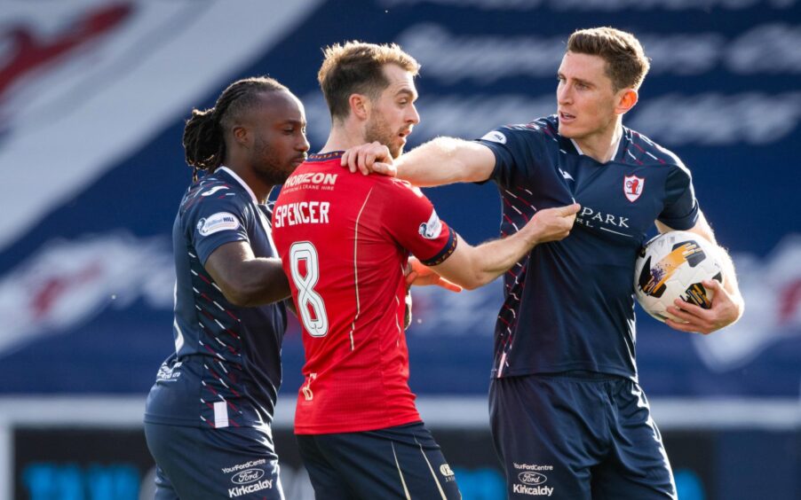 Fankaty Dabo and Raith Rovers team-mate Paul Hanlon tussle with Falkirk's Brad Spencer.