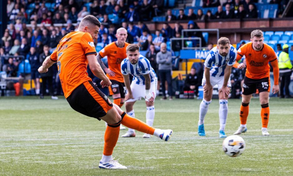 Dundee United defender Ross Graham slots home from the spot,