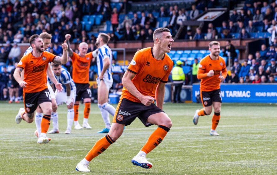 Dundee United defender Ross Graham wheels away in delight