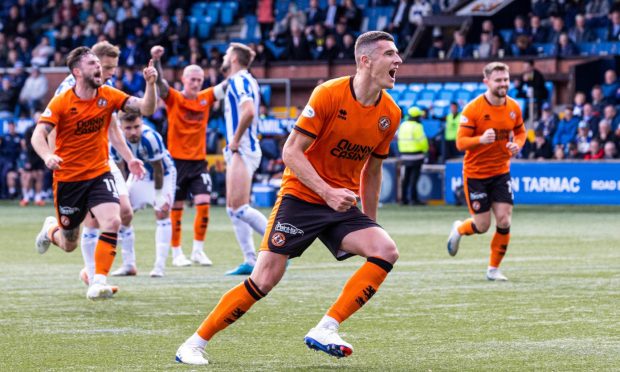 Dundee United defender Ross Graham wheels away in delight