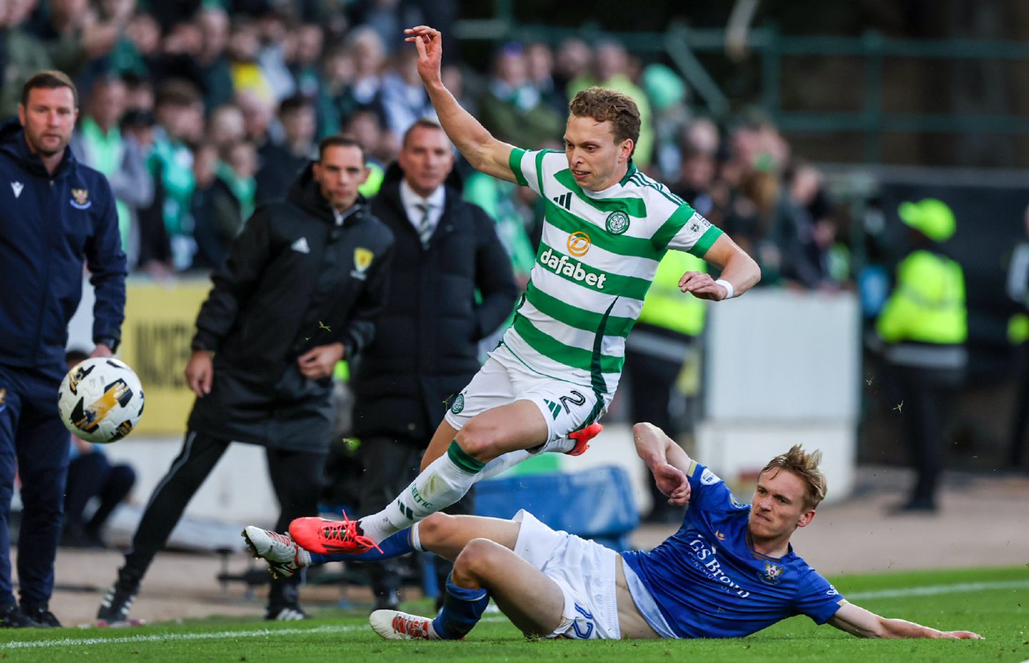 Matt Smith challenges Celtic's Alistair Johnston.