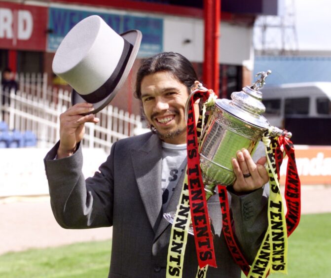 The Argentine forward ahead of the cup final, holding the trophy 