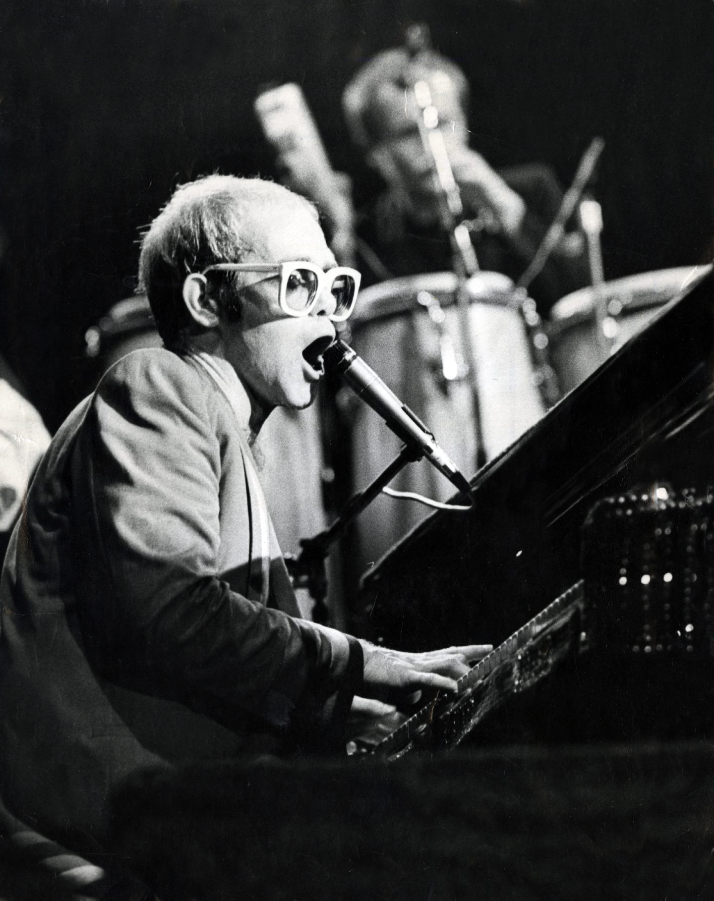 Elton John playing the piano and singing at the Caird Hall in Dundee in 1976.