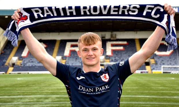 Finlay Pollock holds up a Raith Rovers scarf.