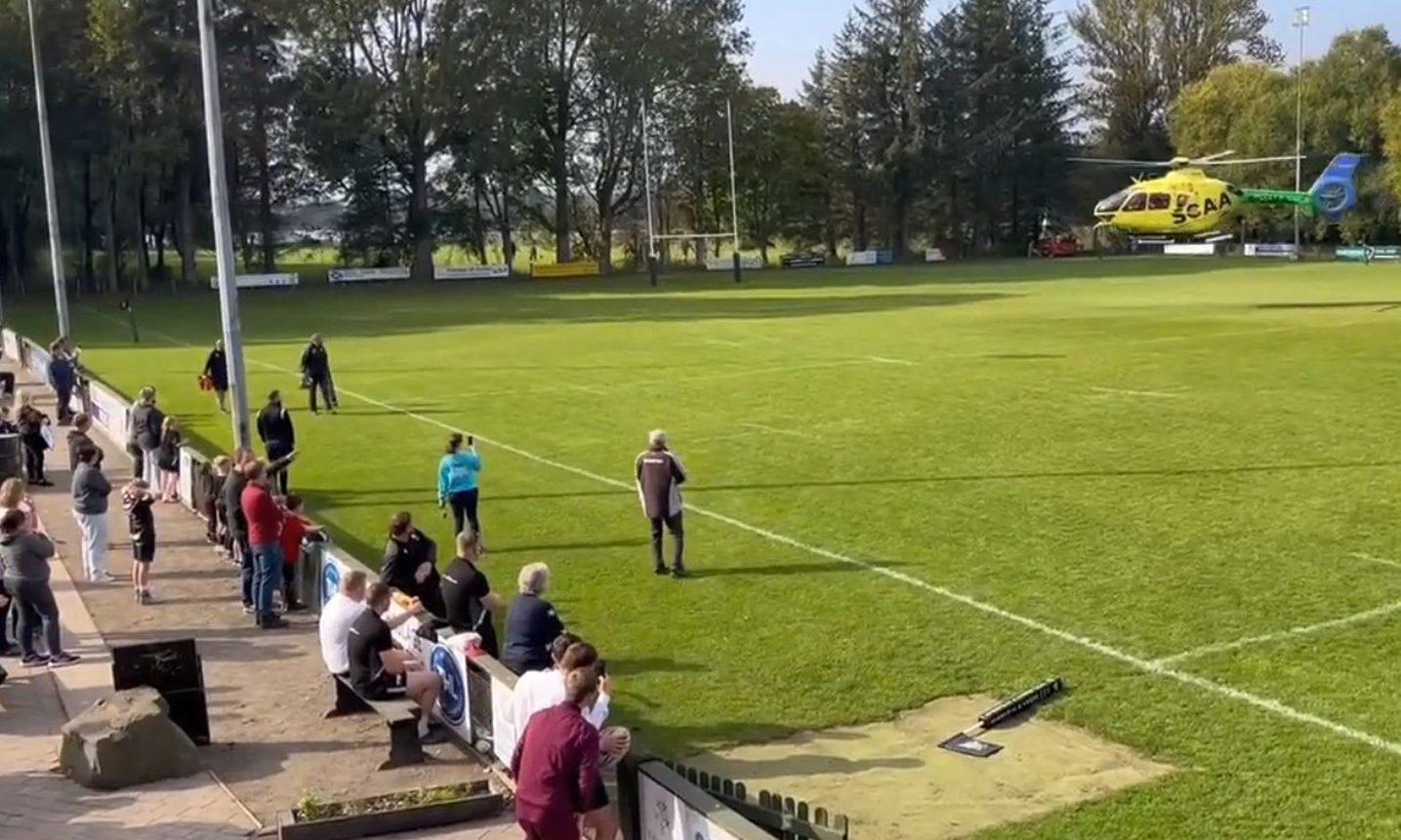 Spectators watch as air ambulance leaves Forfar's Inchmacoble Park