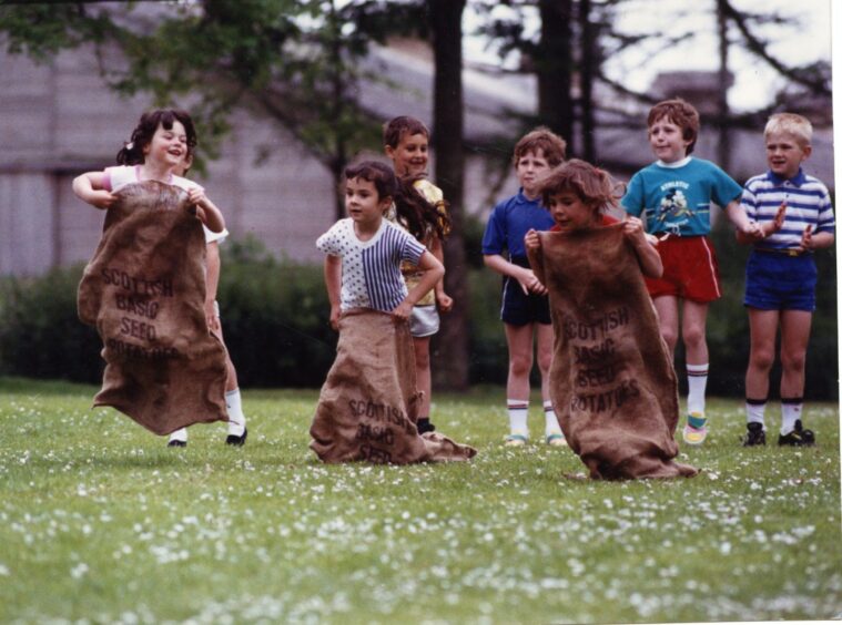 children compete in the sack race