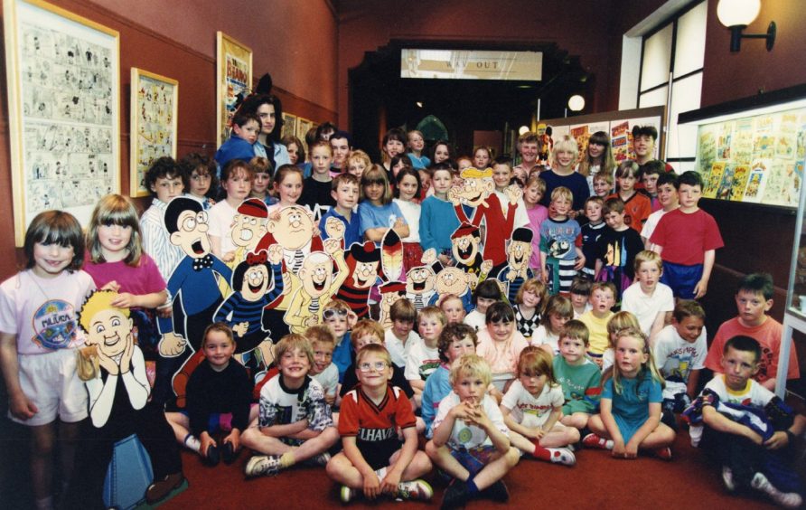 A group of children enjoying a cartoon exhibition at McManus Galleries in Dundee