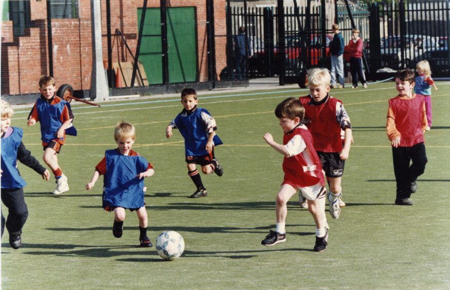 children play football during the Dundee United session. 