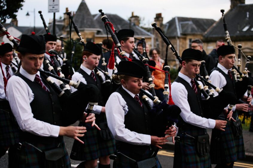 On opening night, Stirling and District Schools Pipe Band lead a procession through the cobbled streets of Stirling. 