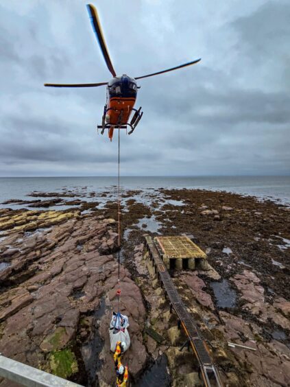 Helicopter dropping equipment on Bell Rock light.