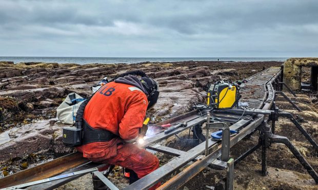 Ross Russell welding the new Bell Rock walkway. Image: Rob Ionides/Northern Lighthouse Board