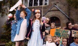 Group of children with placards outside Birnam Library