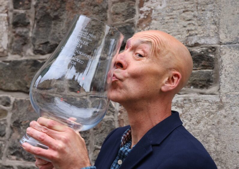 McIlvanney Prize winner Chris Brookmyre kisses his trophy. 