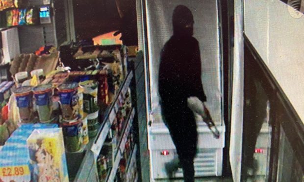 A hooded figure raiding Burrelton Village Store. Image: Gary Casson