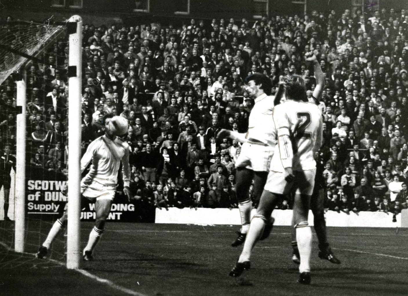 The goalmouth is packed and fans look on as Paul Sturrock scores in the first leg, though the goal was disallowed.