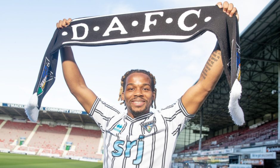 New signing Dapo Mebude holds up a Dunfermline Athletic FC scarf.