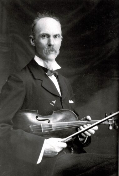 Black and white portrait of James MacIntosh holding a violin