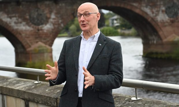 John Swinney, pictured here in Perth, talks politics with his dad, but doesn't now how he votes.