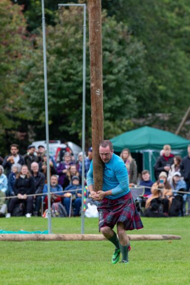 A caber tosser takes a run up. 