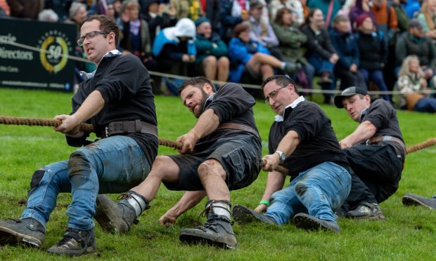 A team shows grit and determination during the Tug o' War at Pitlochry Highland Games.