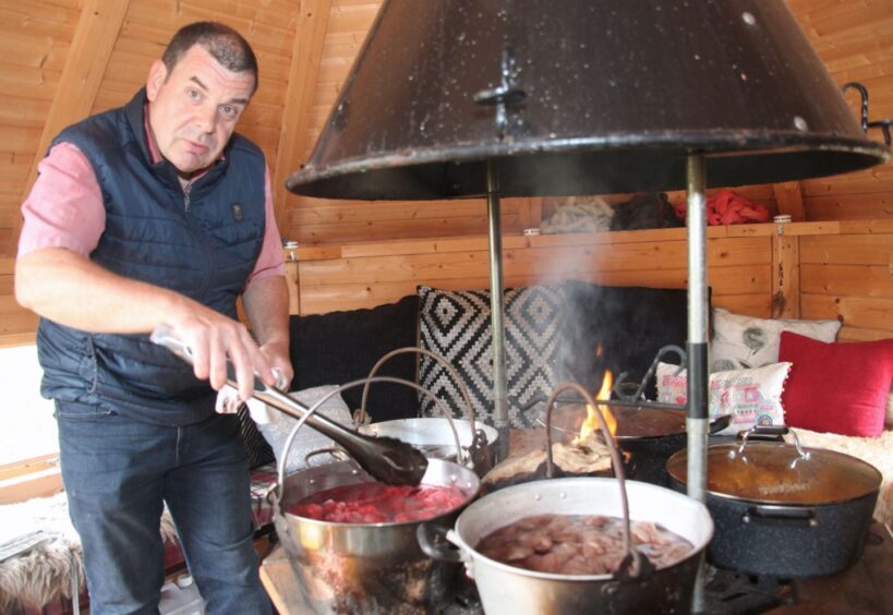 Farm manager Fred Porchez with pots of Cashmere getting dyed. 