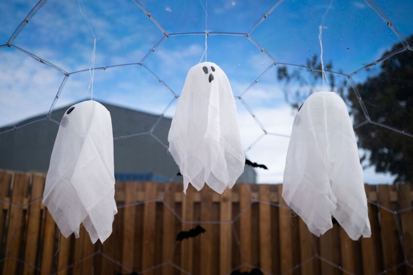 pieces of cloth hang from the ceiling to resemble ghosts