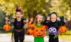 kids in costume make scary faces for Halloween celebrations