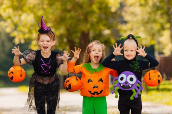 kids in costume make scary faces for Halloween celebrations