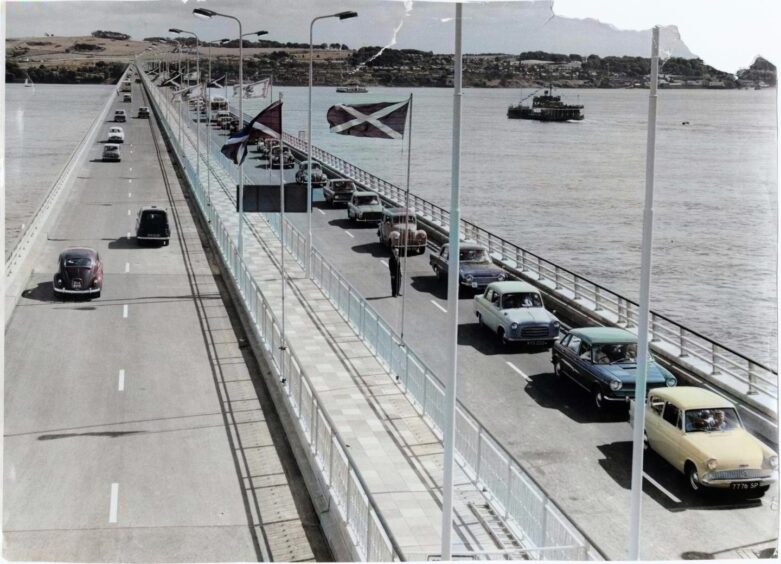 Cars begin passing after the Tay Road Bridge opened.