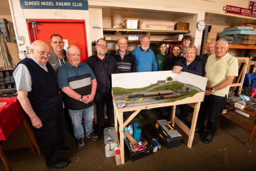 Dundee Model Railway Club members show off a display at their Huntly Square HQ. 