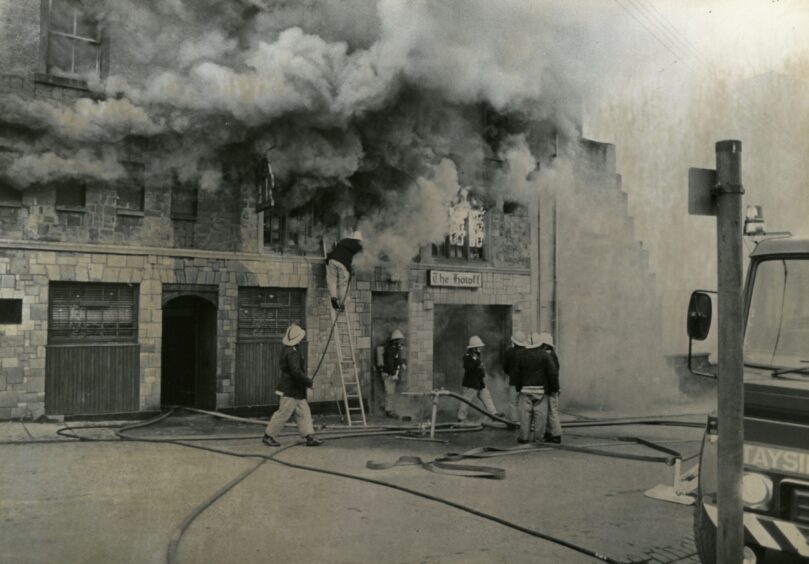 fire crews at the scene as smoke pours out of the pub windows