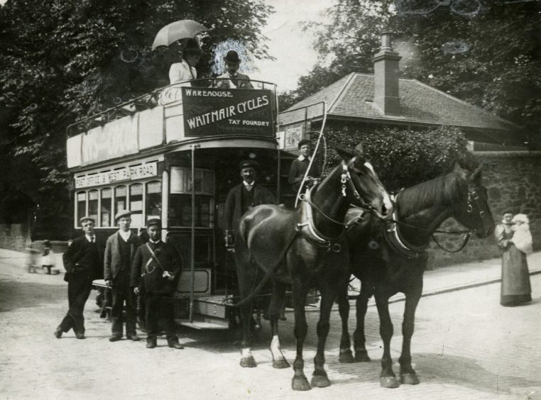 A horse-drawn tram at the bottom of Glamis Road in 1931. Staff and members of the public pose beside the tram, which is pulled by two horses