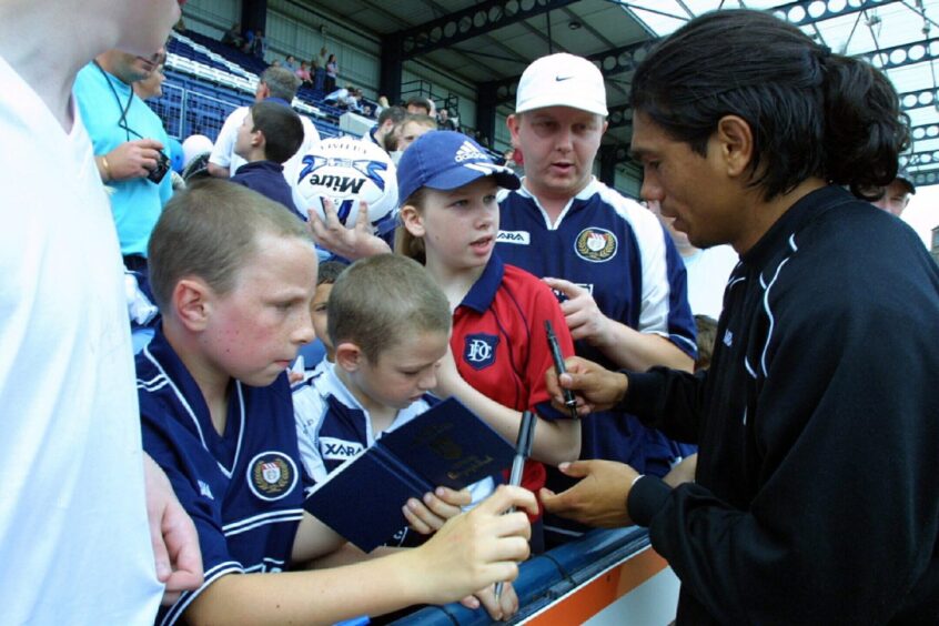 Caballero, who was a fans' favourite at Dens Park, signing autographs for fans in the stand