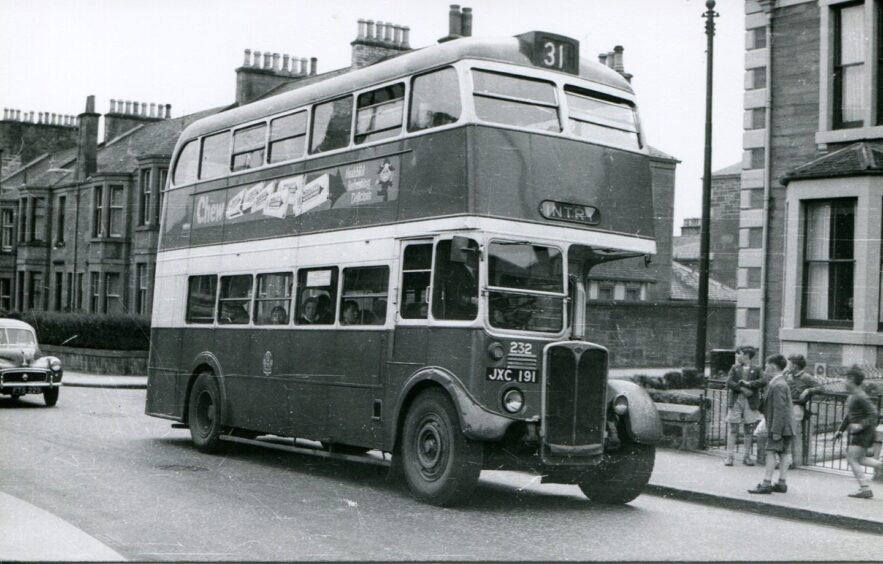 Bus 232 passes some school children on the 31 to Fintry in the 1950s. 