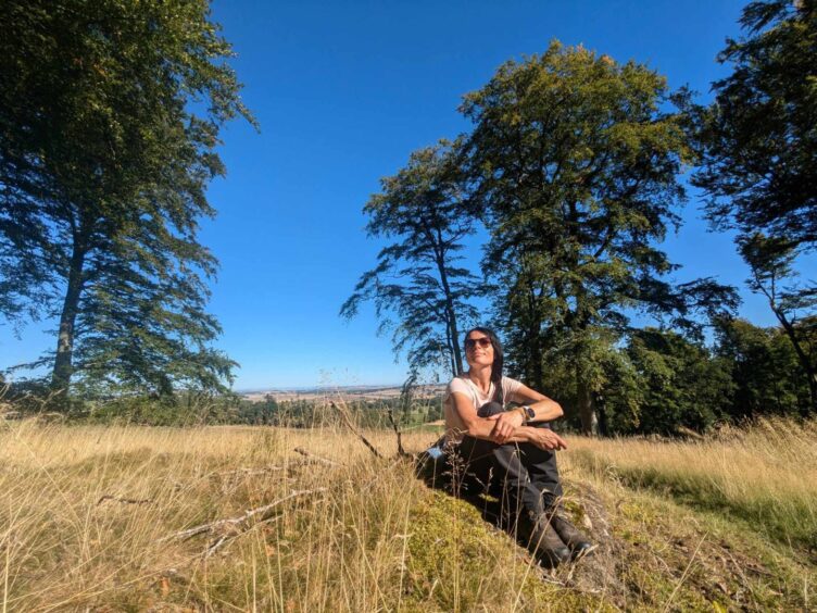 Gayle sits down for a rest on near the summit of Fothringham Hill. Image: Gayle Ritchie.