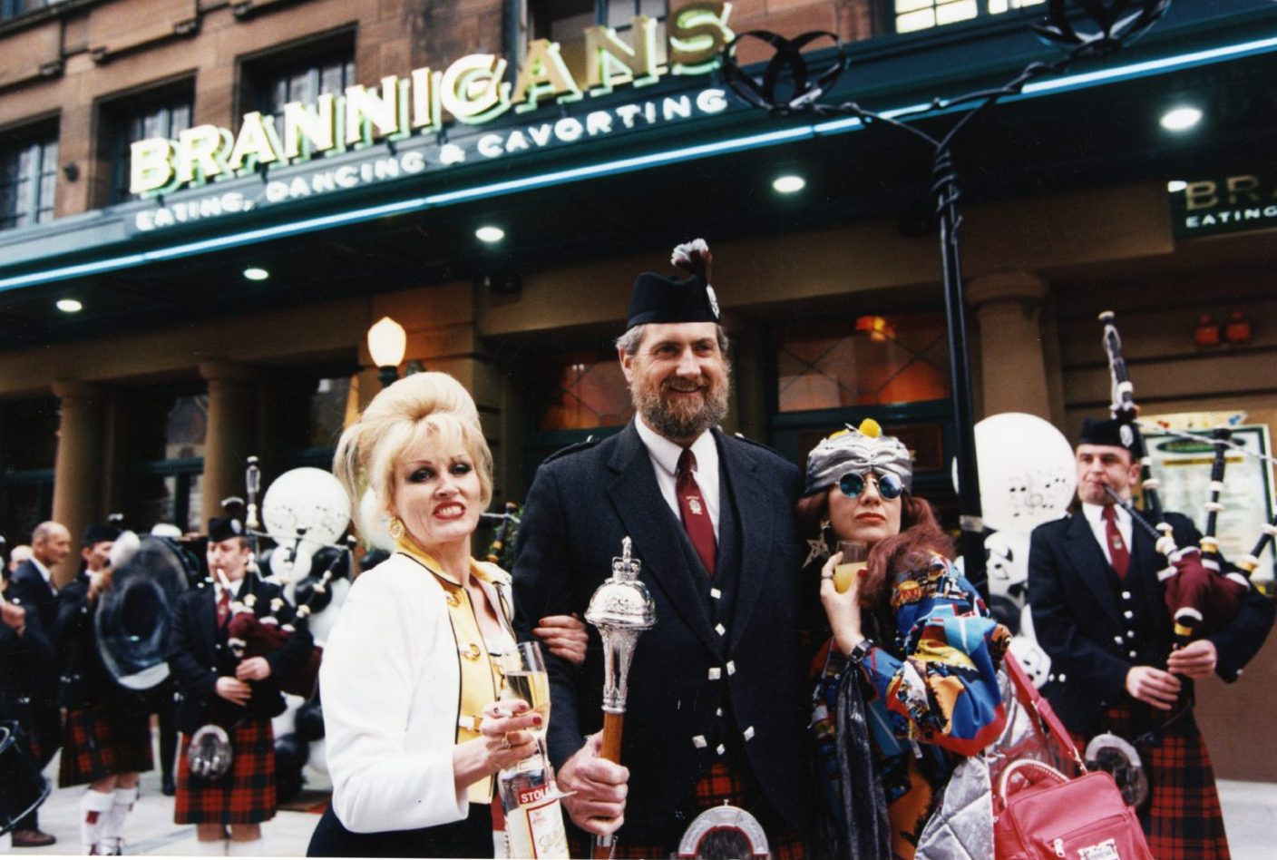 Absolutely Fabulous lookalikes beside a pipe band leader outside Brannigans bar in Dundee