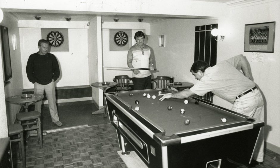 Two men playing pool at the games room at Invergowrie Inn. 