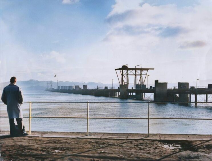 A man looks out onto the Tay Road Bridge construction in 1963.