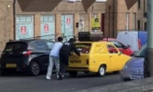 Two young lads were seen pushing the car to safety. Image: Supplied