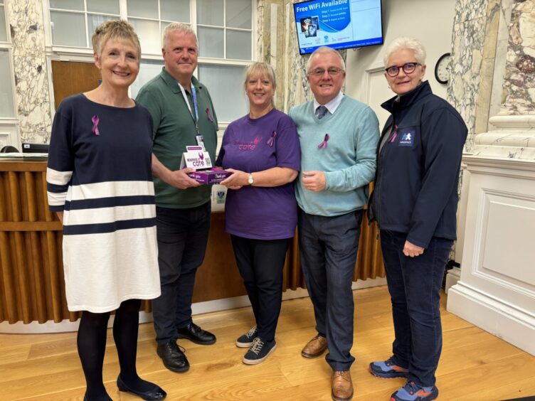 Group of people collecting box on menopause awareness ribbons at Perth and Kinross Council HQ